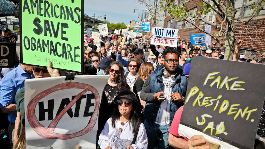 Protesters rally near the Intrepid Air and Sea Museum where President Trump is expected to visit.