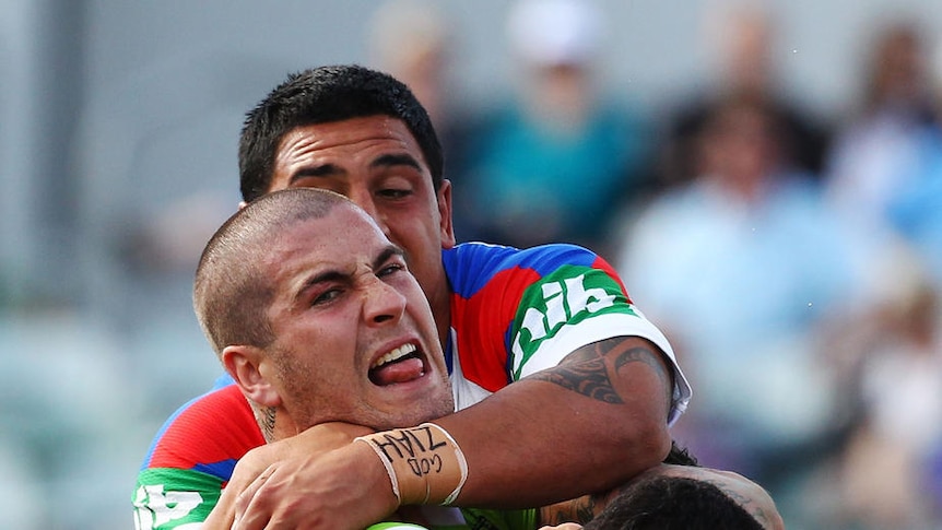 Collared... Raiders forward Joel Thompson is brought down by the Knights defence.