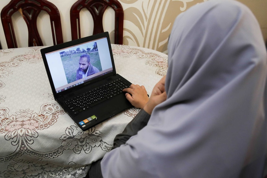 Ms Morsy looks at a recent picture of her husband Fadl El Mawla, 53.