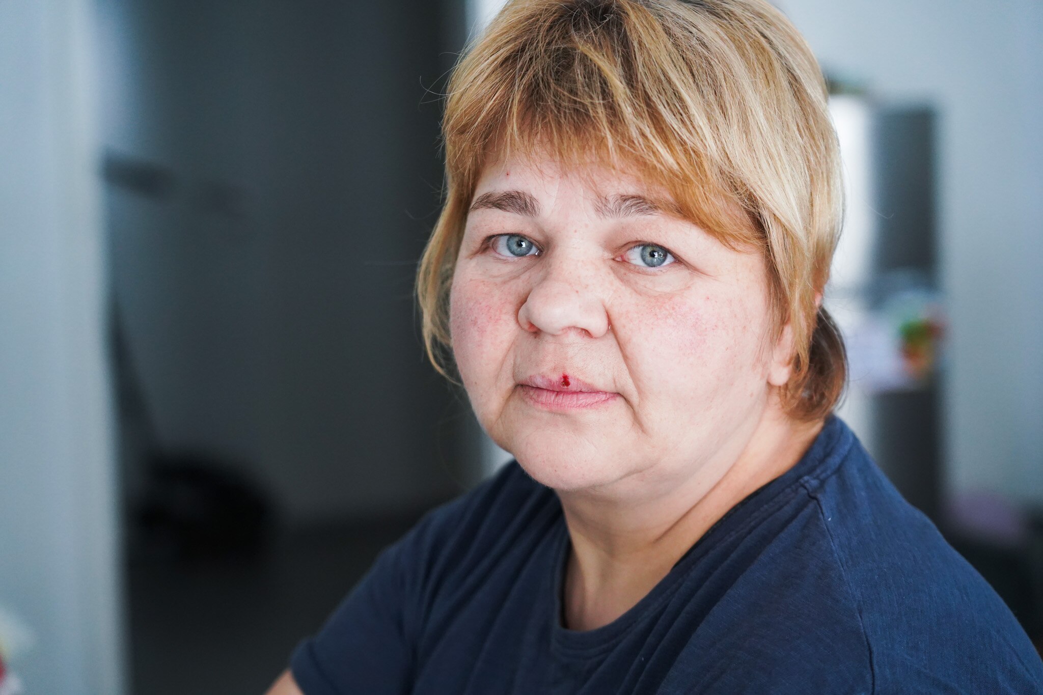 A close up of a woman with blonde hair and blue eyes.