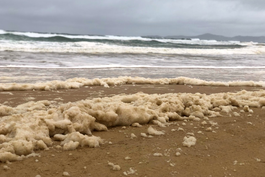 Foam washed up on Teewah Beach as a storm brews