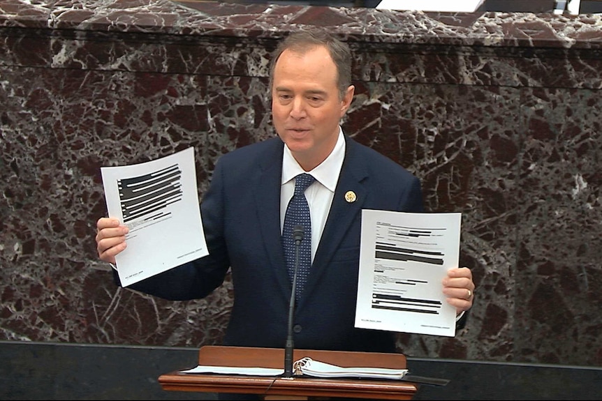 Adam Schiff, D-Calif., holds redacted documents as he speaks during the impeachment trial against President Donald Trump in