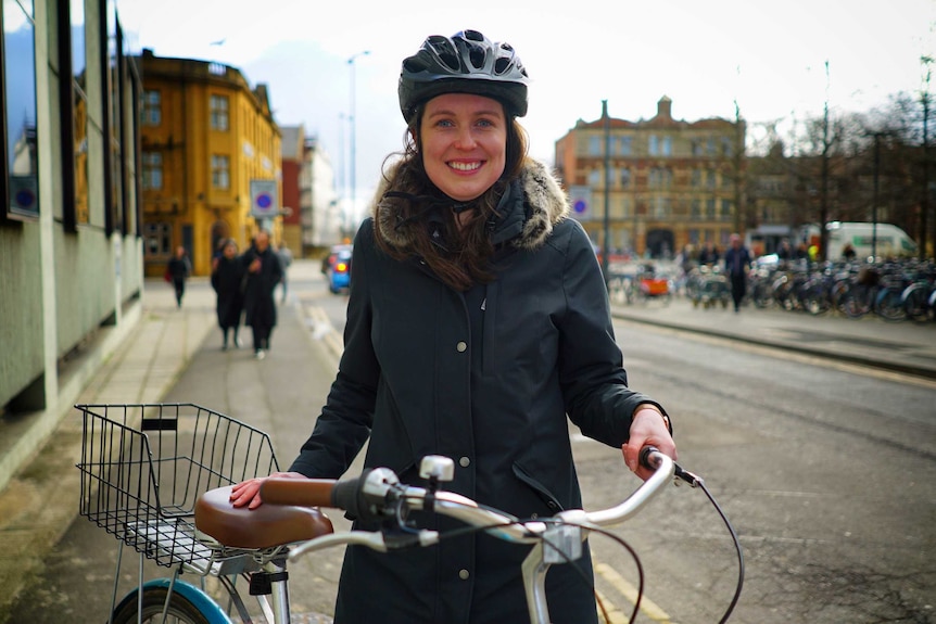 Australian Meredith Caldwell stands with her bike in the streets of oxford