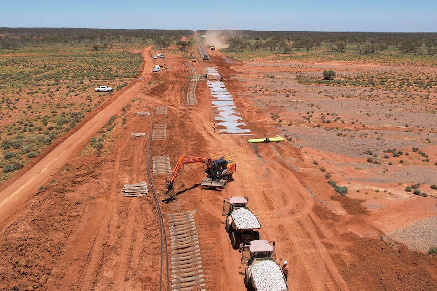 a drone shot of an excavator working on a damaged rail line