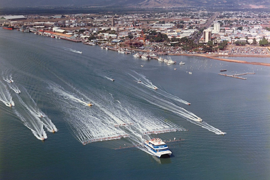 A small flotilla of boats trail behind 100 water-skiers attempting to set a new world record in Cairns on October 18, 1986.