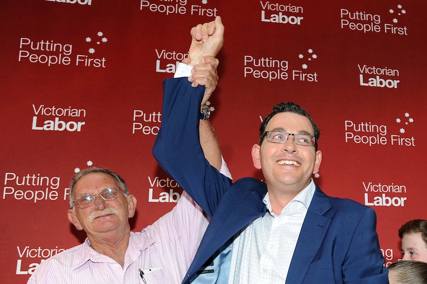 Bob Andrews holds up Daniel Andrew arm after the 2014 election.