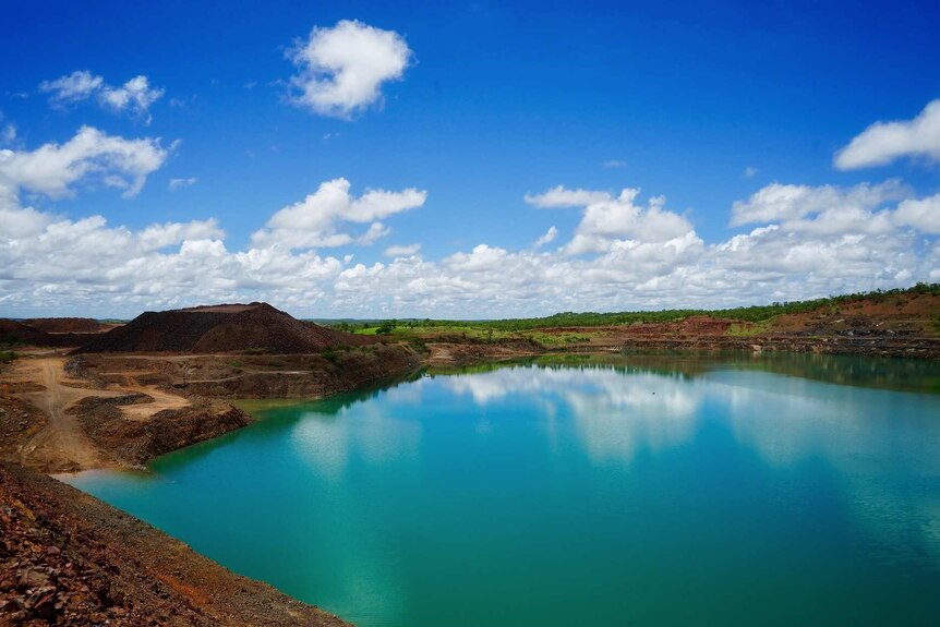 Eight litres of vibrant green, acidic water sits in the Batman open cut pit, that has been treated with lime to raise the pH.