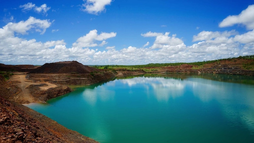 Eight litres of vibrant green, acidic water sits in the Batman open cut pit, that has been treated with lime to raise the pH.