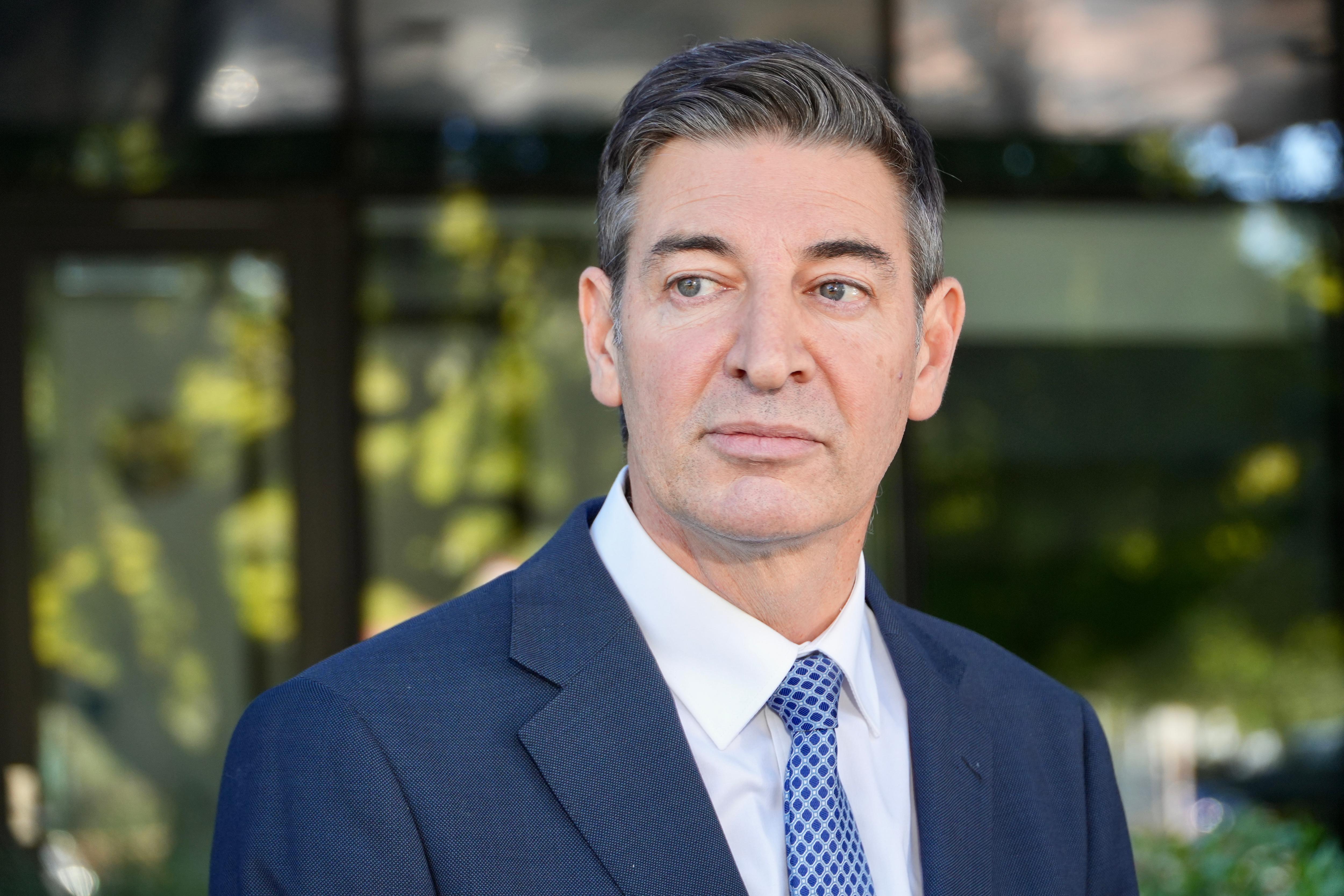 Basil Zempilas wears a suit and looks serious.