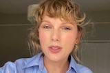 A close-up of Taylor Swift looking at the screen