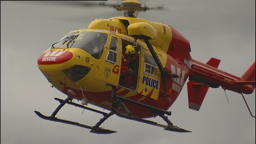 Tasmanian police rescue helicopter flies over trees