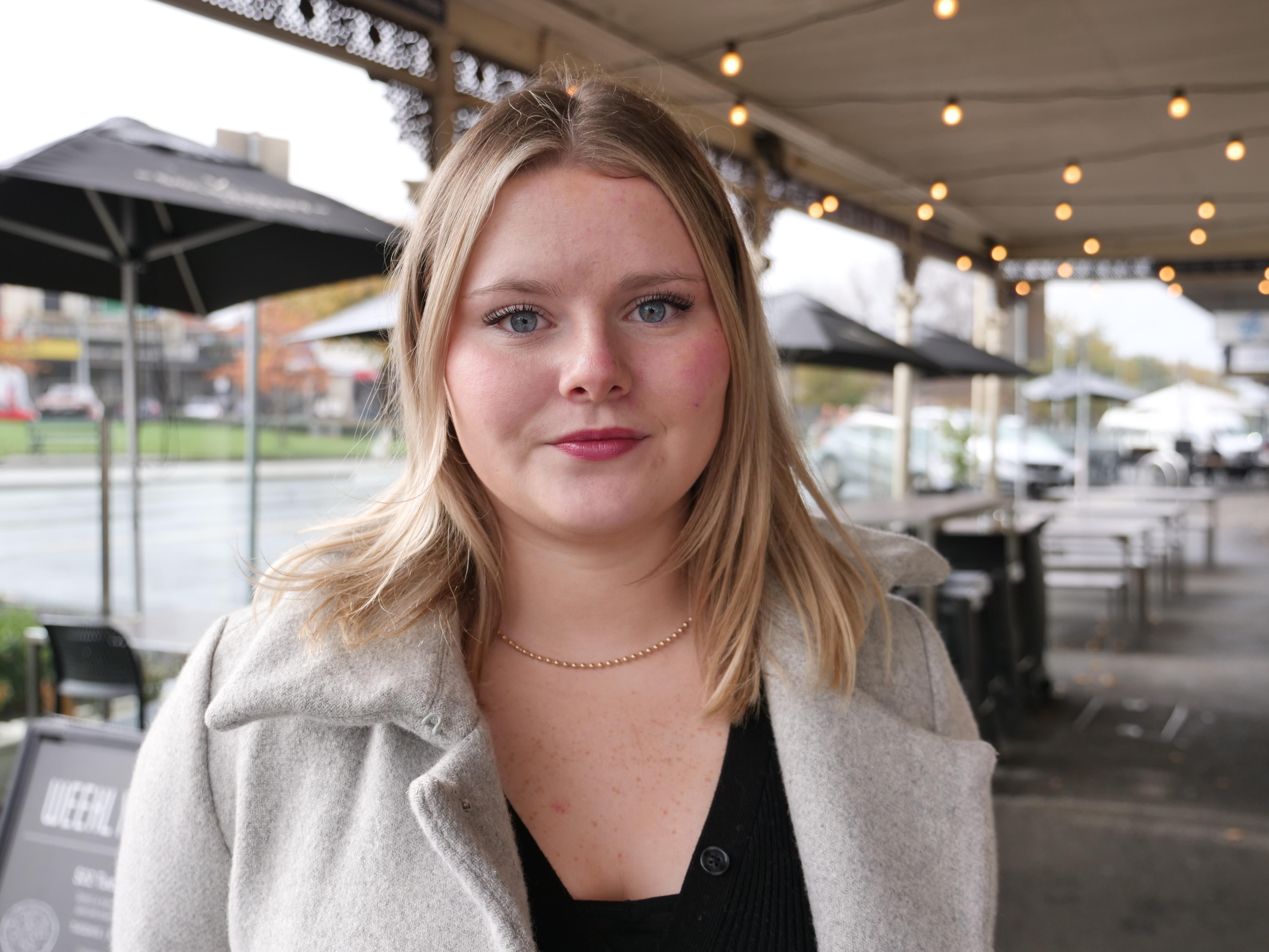Woman with blonde hair looking into the camera. 