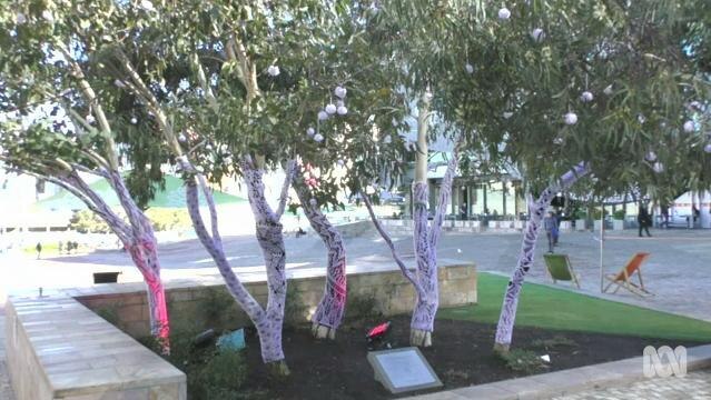 Trees in Federation Square Melbourne with painted trunks