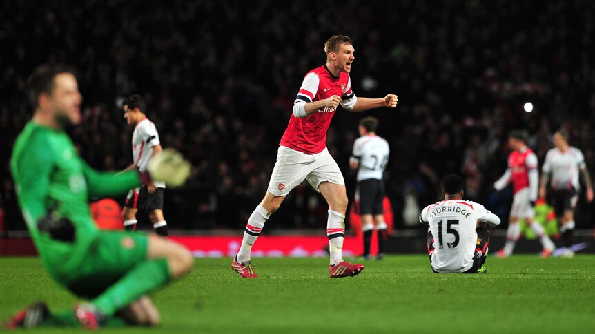 Per Mertesacker celebrates after downing Liverpool in the FA Cup
