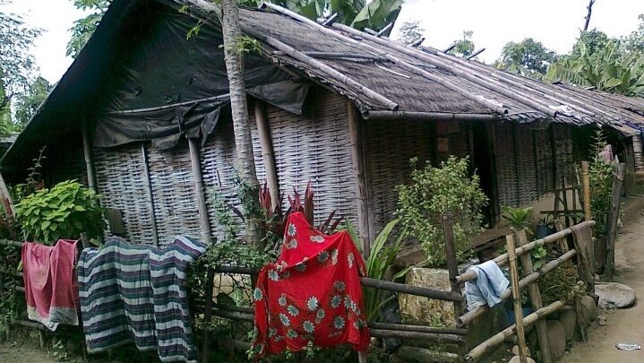 A thatched roof and wall hut that was Mr Poudel's family's home for 18 years.