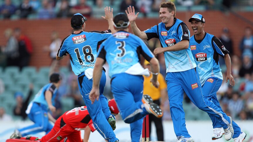 Adelaide Strikers players celebrate after getting a Renegades wicket