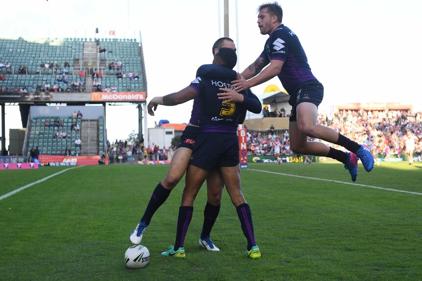 Josh Addo-Carr is congratulated by his team-mates on a try for the Storm against the Dragons in Wollongong on April 30, 2017.