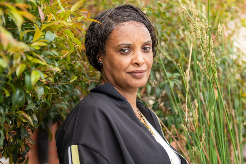 Ethiopian refugee Meseret Tola outside her brother Fikru's home.