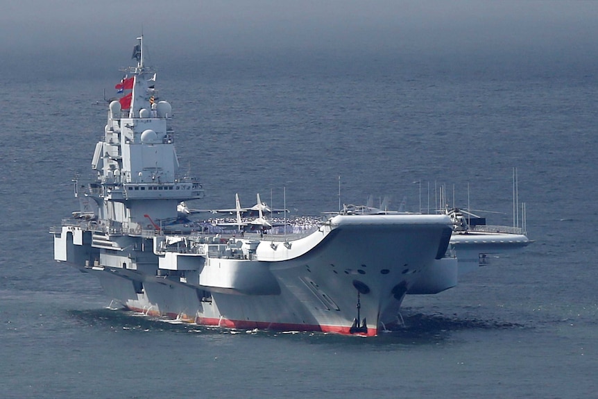 Members of the People's Liberation Army navy are seen on board China's aircraft carrier Liaoning.