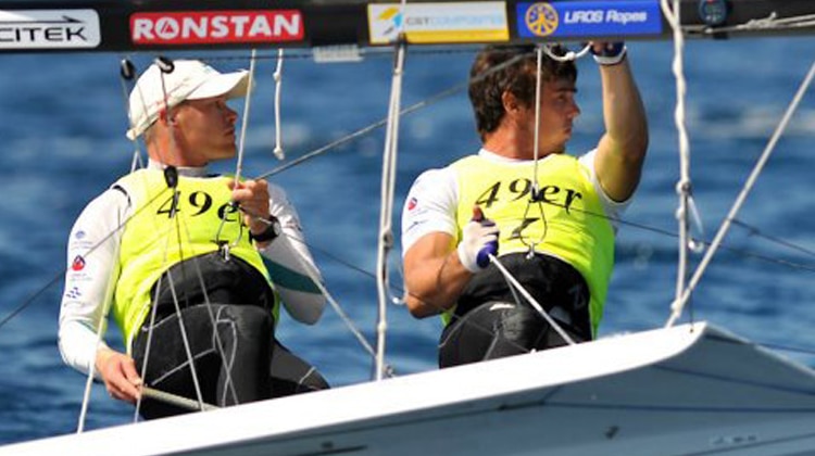 Lake Macquarie's Nathan Outteridge and Iain Jensen capsize at the Olympic Regatta, but still lead overall.