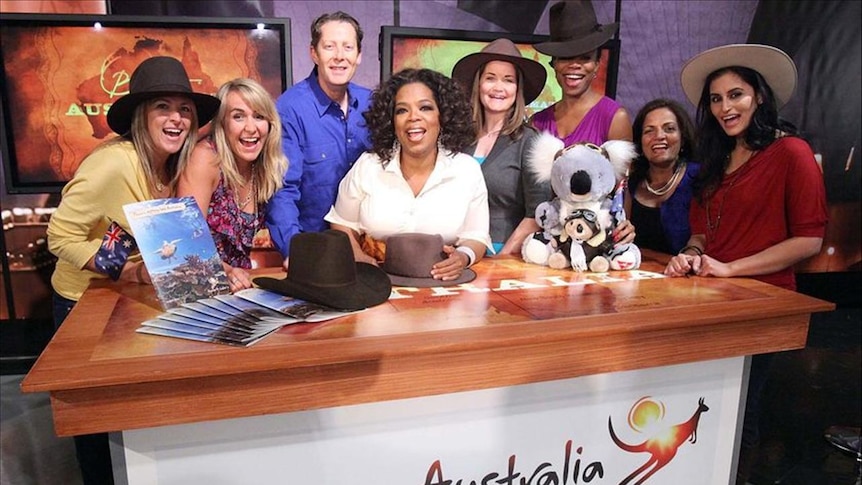 Oprah Winfrey and fans pose for a photo ahead of a trip to Australia