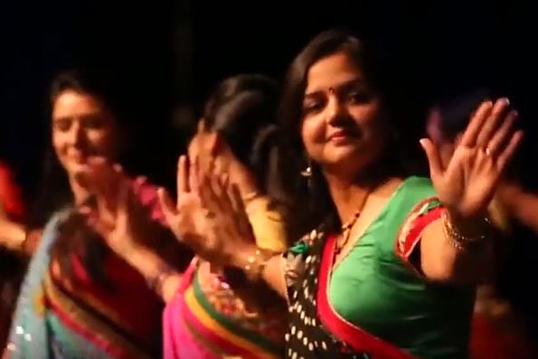 Priyanka Mishra wearing a green sari dances Bollywood style with other women