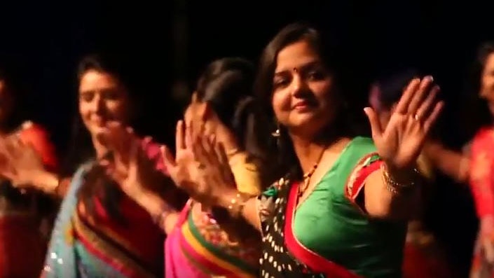 Priyanka Mishra wearing a green sari dances Bollywood style with other women