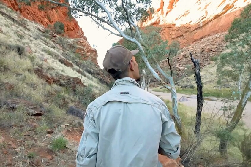 National Parks Ranger walking through a canyon in Northern Australia.