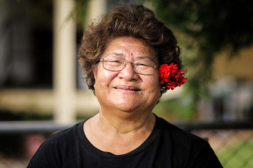 Elderly woman with a flower in her hair. 