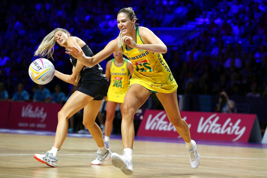 Two women tussle over a netball