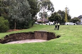 Water partially filled a large sinkhole at Kew, Victoria.