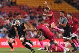 Crusaders player Peter Samu (L) with the ball against the Reds at Lang Park on March 11, 2017.
