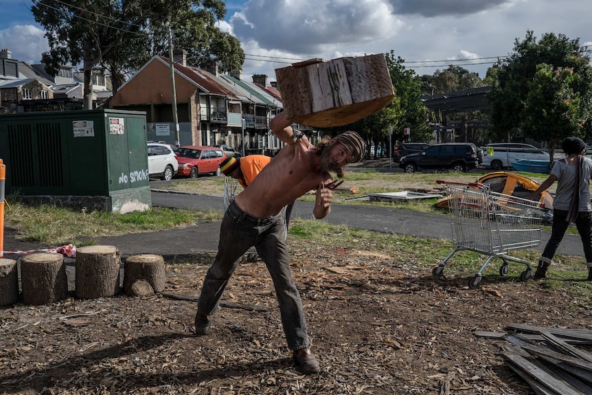 Neil Owen stacks firewood for the camp.