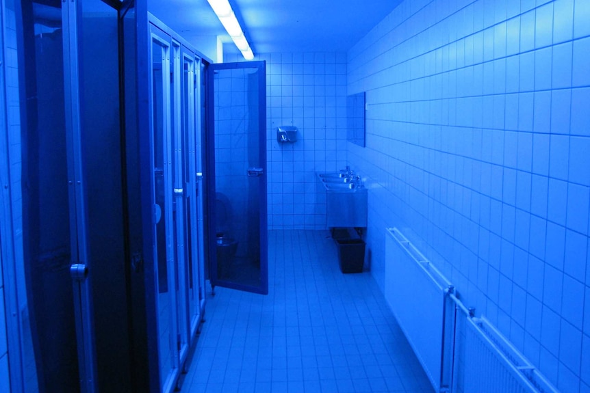 Blue lighting in a bathroom at a train station in Finland.