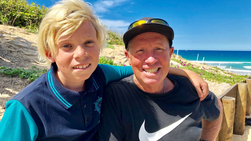 An 11-year-old boy and his dad by the beach.