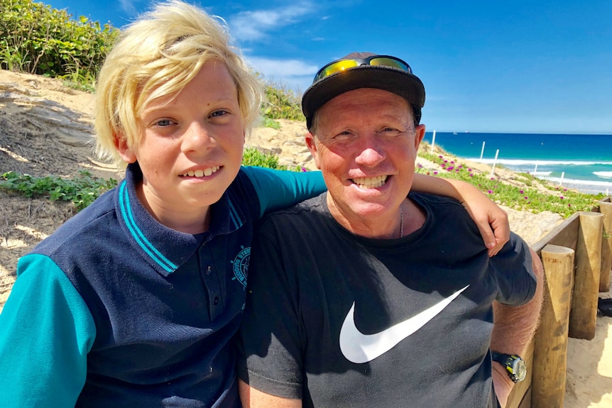 An 11-year-old boy and his dad by the beach.