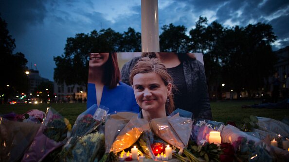 An image of Jo Cox is surrounded by candles in memorial