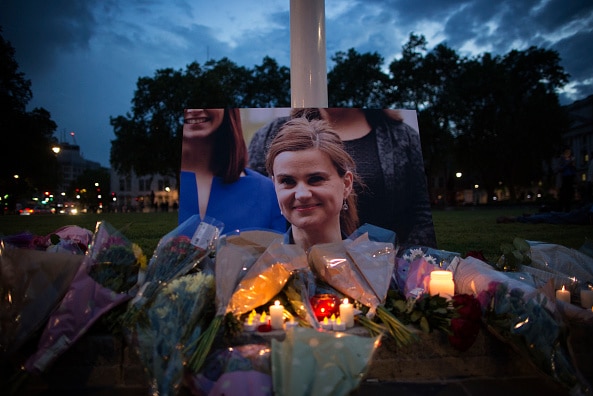 An image of Jo Cox is surrounded by candles in memorial