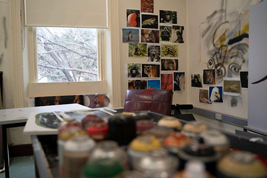 A room with pictures and paintings on the wall