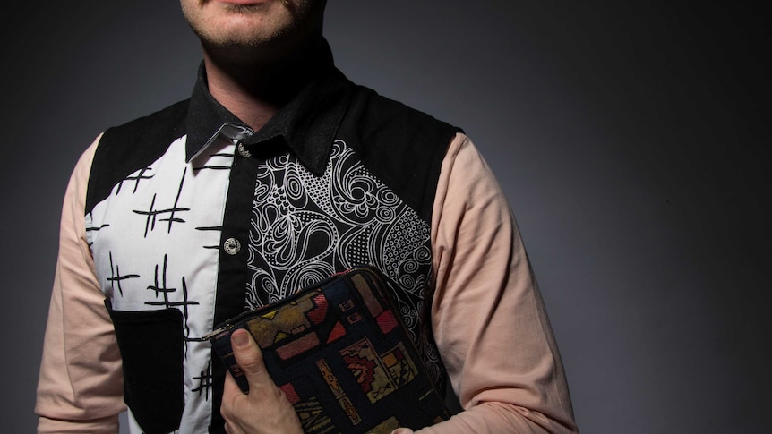 Liam Webb in patterned shirt holding bible.