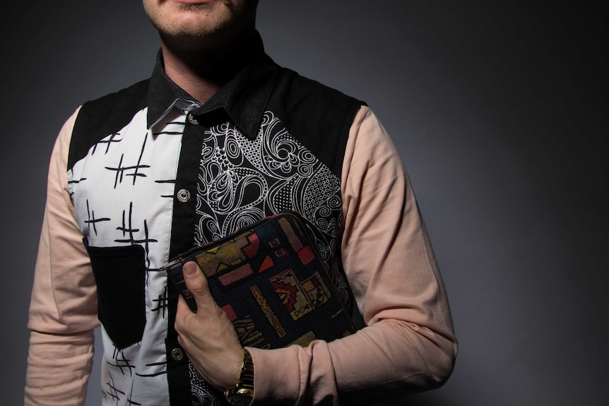 Liam Webb in patterned shirt holding bible.