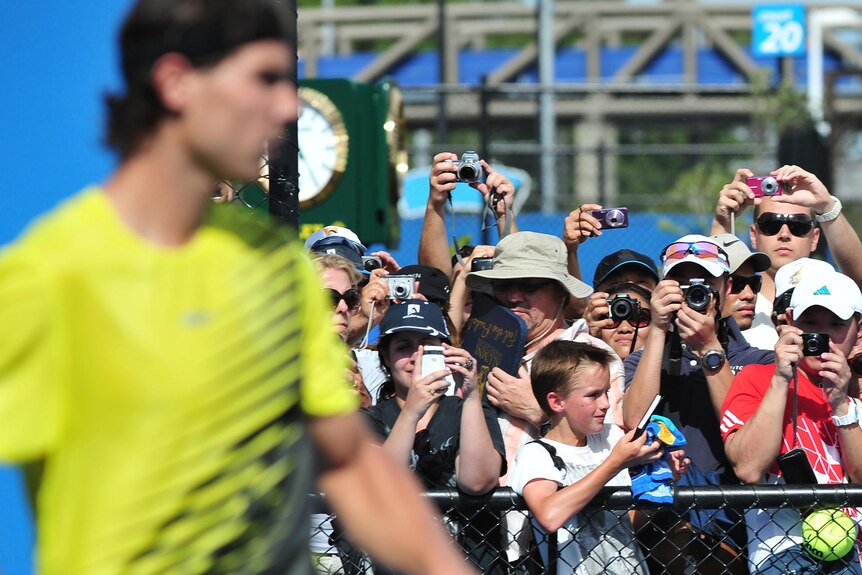 Fans try to take photos of Rafael Nadal as he practices during the Australian Open.