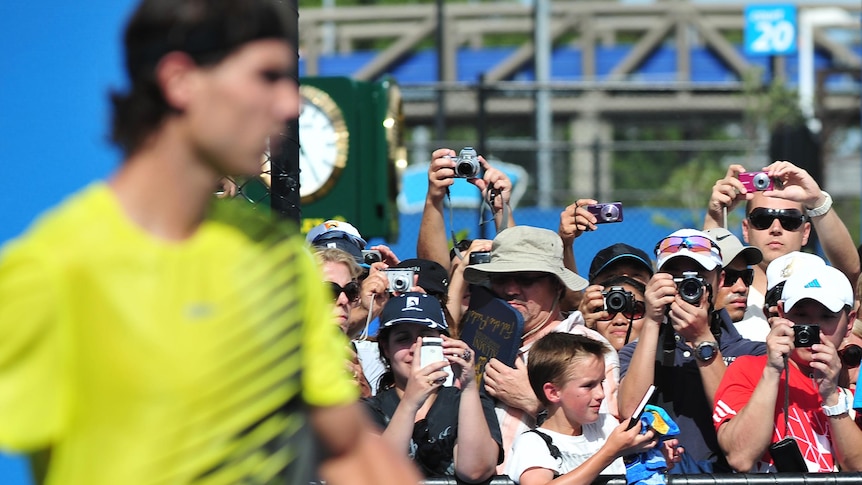 Fans try to take photos of Rafael Nadal as he practices during the Australian Open.