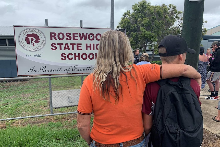 Anonymous mother and son stand in front of Rosewood State High School.