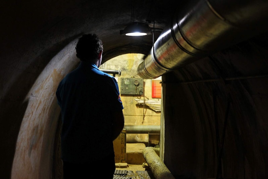 A photo of Rob Marchant from behind as he walks through the trunnels.