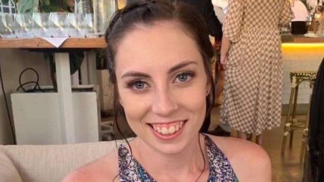 A woman sitting on a couch smiling 