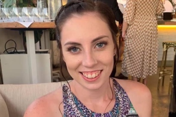 A woman sitting on a couch smiling 