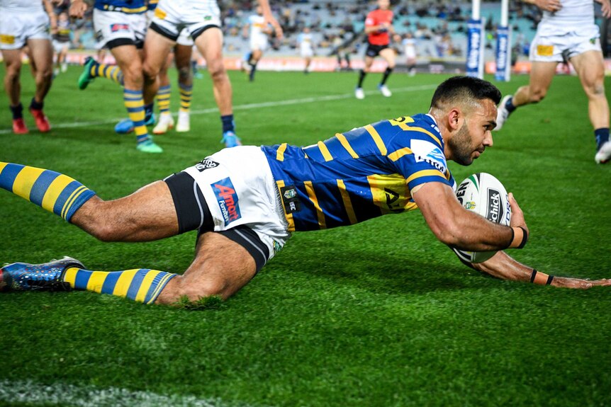 Bevan French of the Eels scores against the Titans at the Olympic stadium.