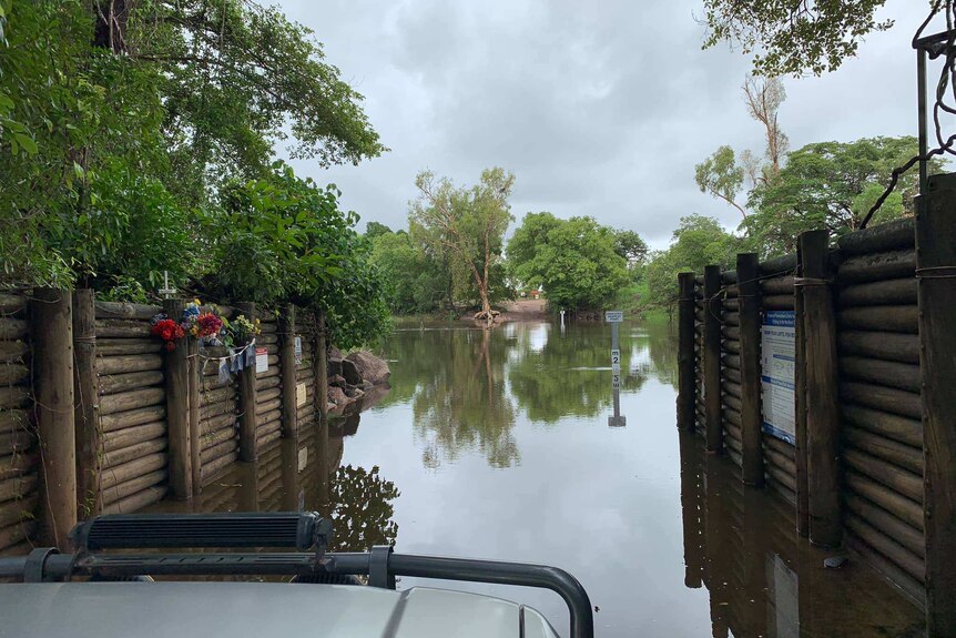 Cahills crossing is seen flooded behind the window of a four-wheel-drive.