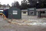 High water: flooding from Ithaca Creek inundates Red Hill businesses.
